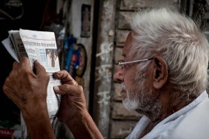 Older man reading news